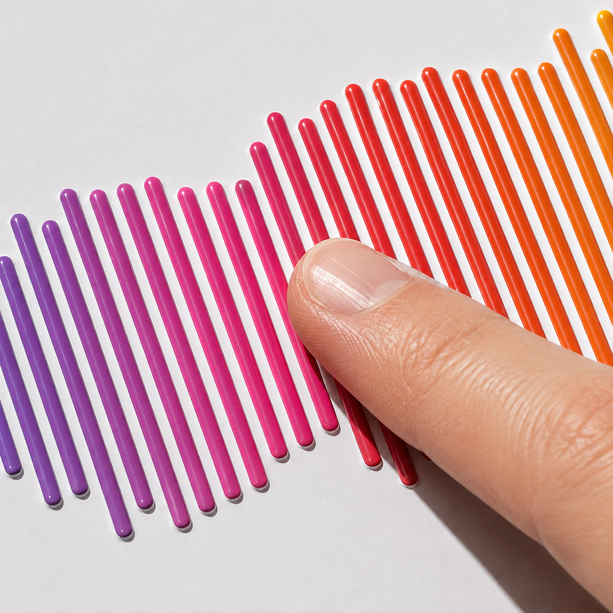 Thumb mid-swipe across raised UV ink waveform bars on a white tin lid